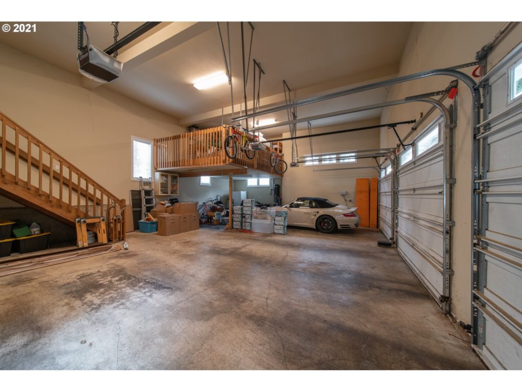 garage interior with bikes and sports car